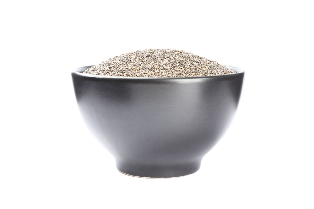 Chia seeds and bowl isolated on plain background