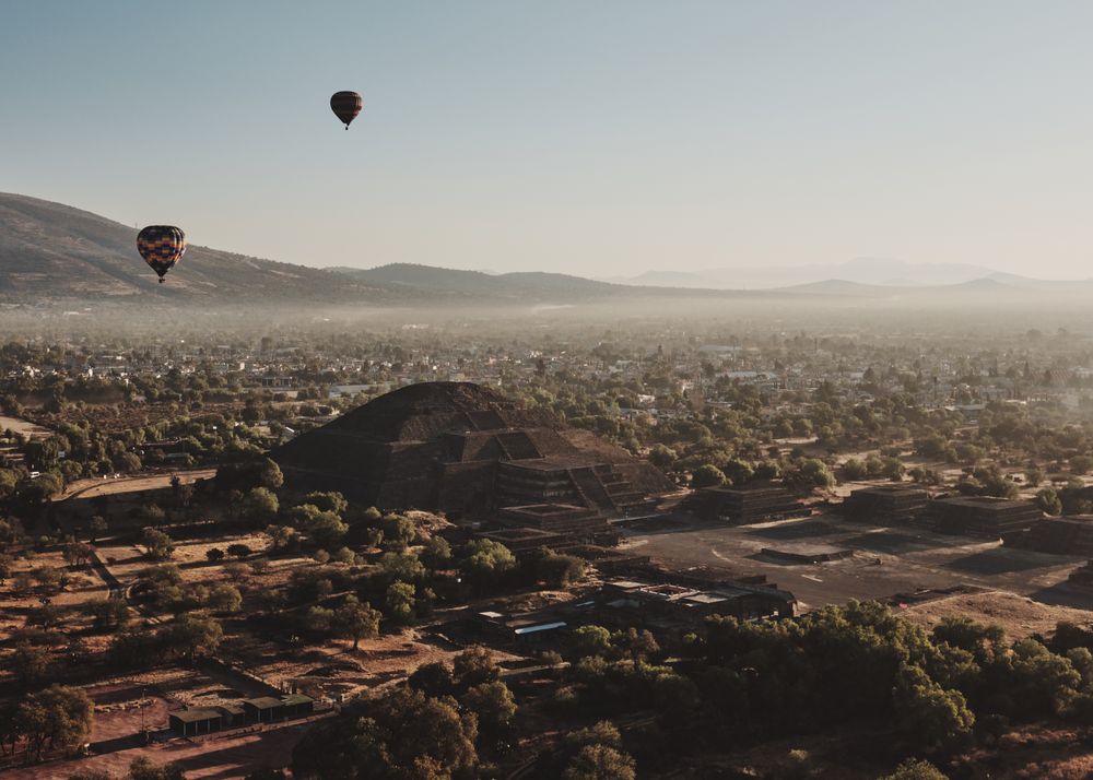 View of two hot air balloon in next to pyramid in Teotihuacan Valley