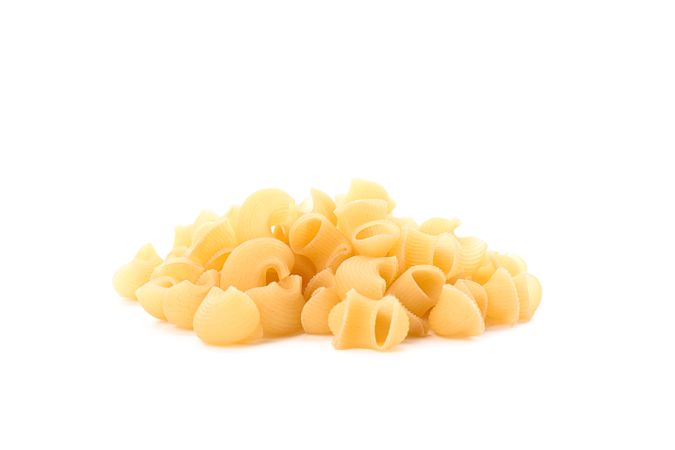Pasta isolated on light background, closeup. Dry uncooked whole pasta
