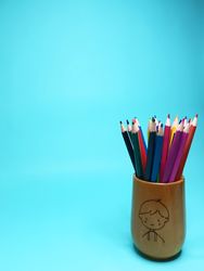color pencils stored in a wooden container