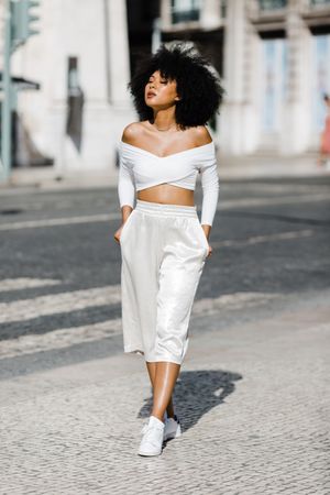 Young stylish female walking outdoors