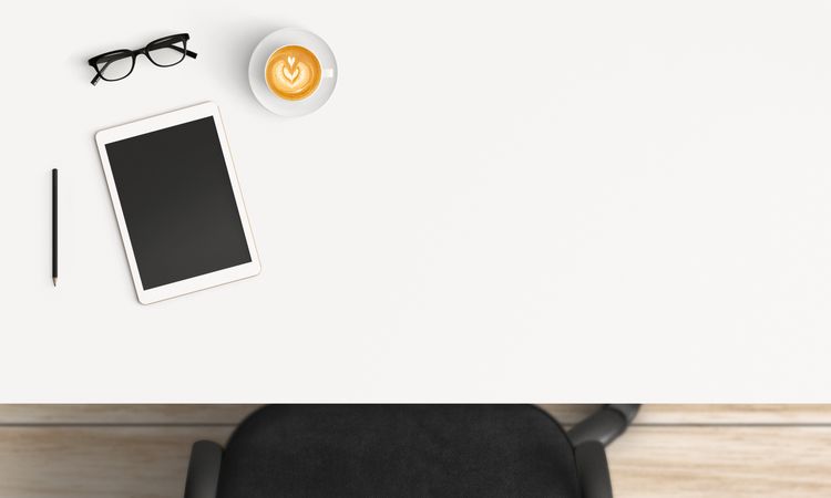 Modern workplace with coffee cup and smartphone or laptop copy space on table background. Top view. Flat lay style.
