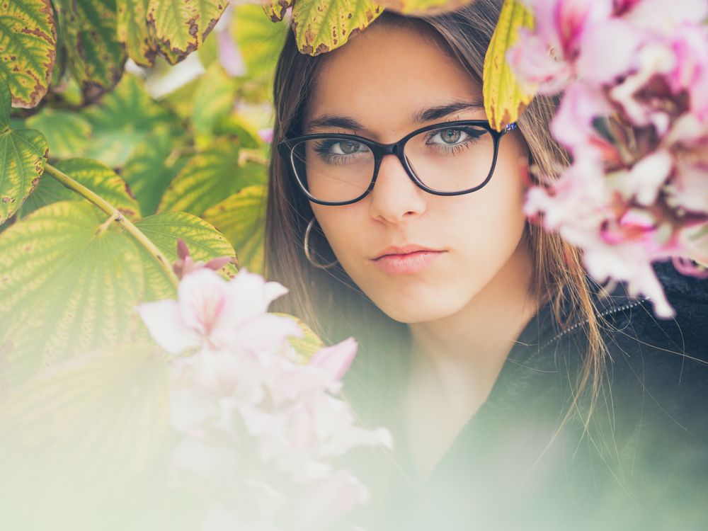 Portrait of woman among blooming trees