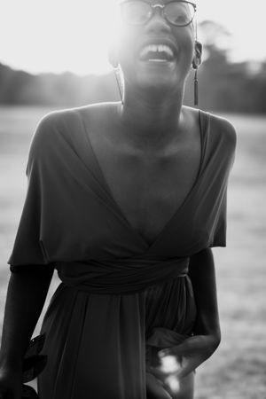 Woman wearing v neck dress laughing in grayscale