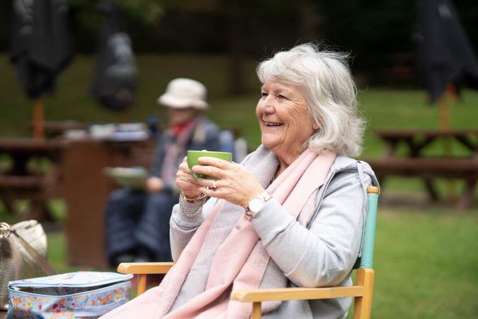 Smiling woman enjoying tea outside
