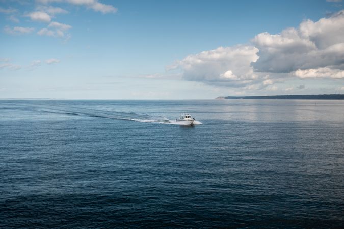 Boat speeding through water on summer's day
