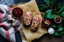 Raw abkhazura meat cutlets with pomegranate seeds & bay leaves