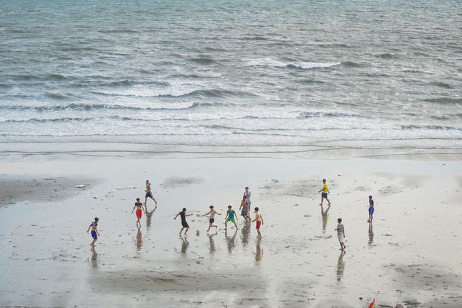 Top view of teenage boys playing on the beach