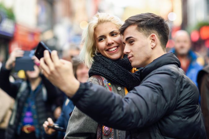 Male and female taking selfie in UK street