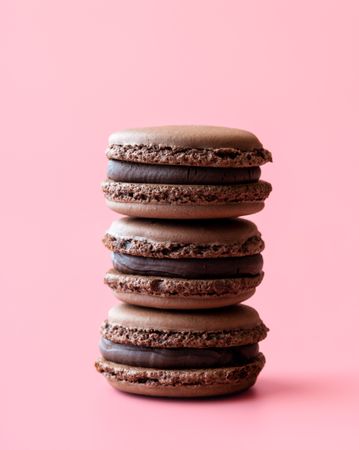Chocolate macaroons isolated on a pink background