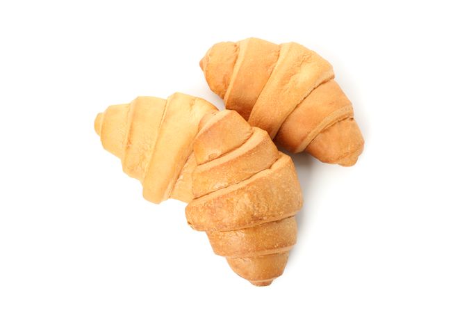 Two croissants isolated on plain background, top view