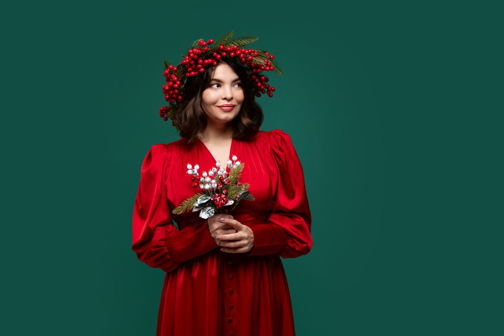Portrait of woman in red dress with berry wreath