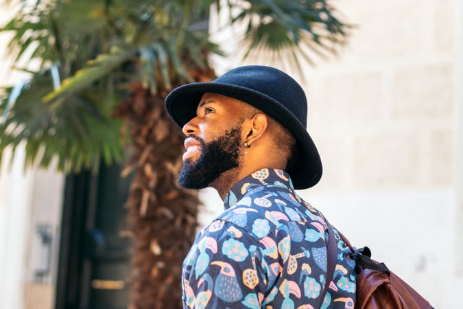 Stylish Black man walking on the city street