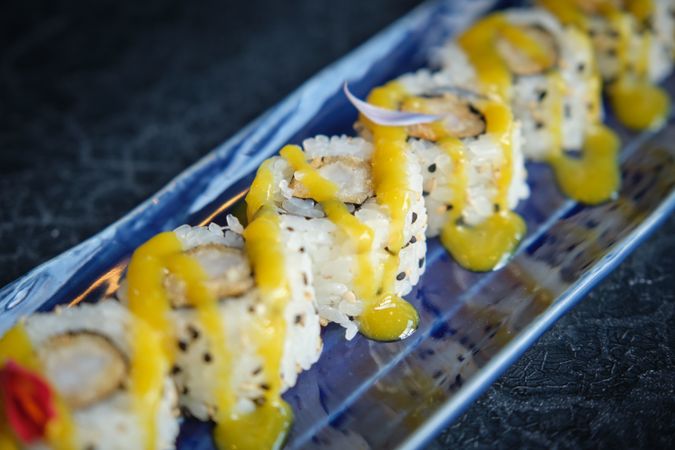 Delicious sushi pieces with battered prawns and soy sauce