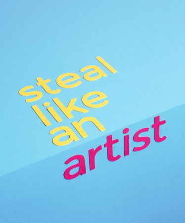 Steal like an artist quote made of paper over blue background