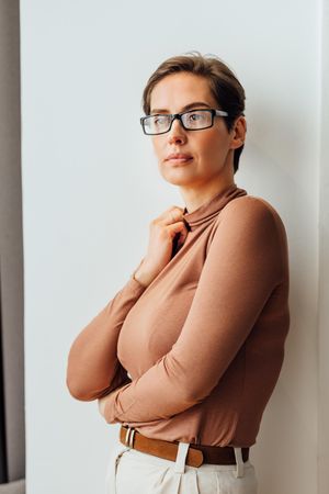 Portrait of a businesswoman in formal wear standing at wall