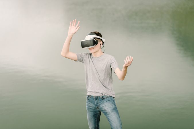Young teenager with virtual reality glasses outdoors