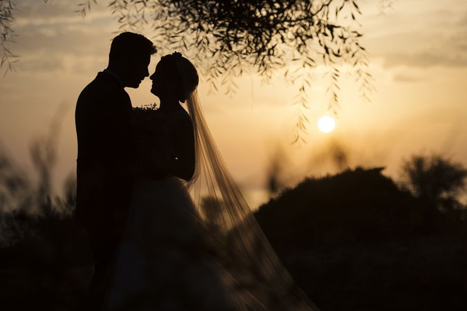 Marriage of woman and man embracing in darkness