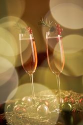 Champagne glasses near Christmas baubles