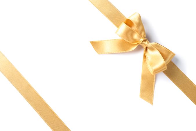 Golden ribbons with bow isolated on blank background. Gift concept