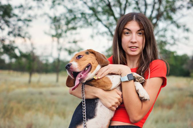 Young woman holds dog beagle