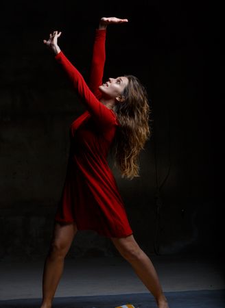 Young woman dancing in darkness