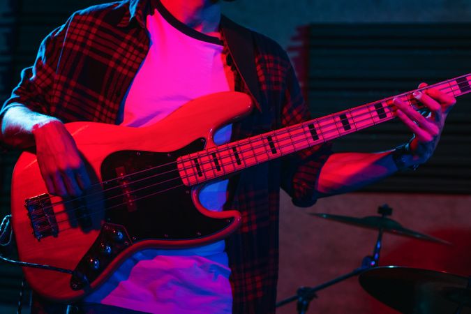 Bass Player Performing In A Live Concert