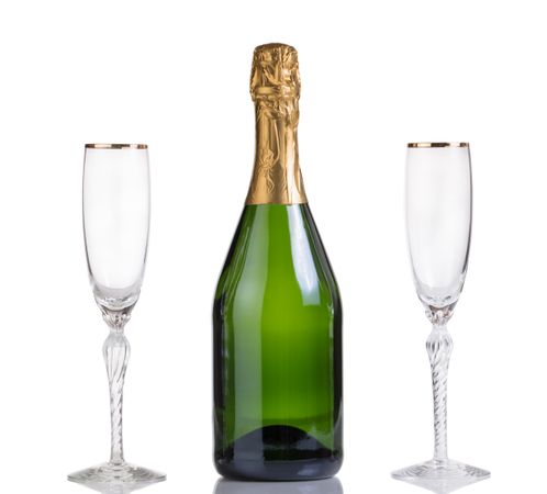 Unopened bottle of champagne and drinking glasses