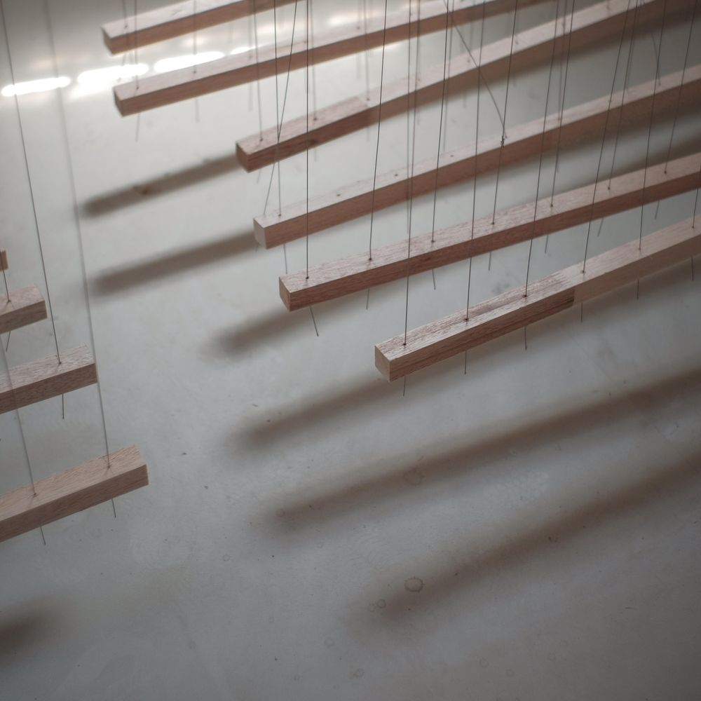 Wooden rod hanging against light background