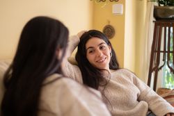 Smiling Young woman talking with her mother.