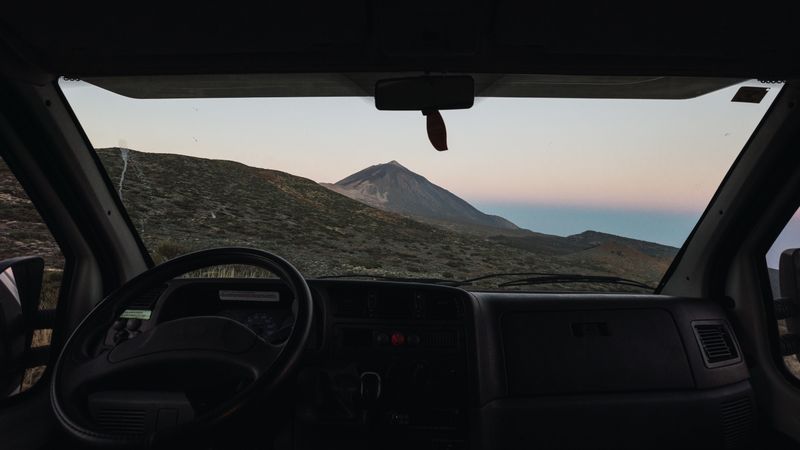 View of mountain through window of car