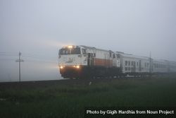 Train with headlights on misty day 5XvY7b