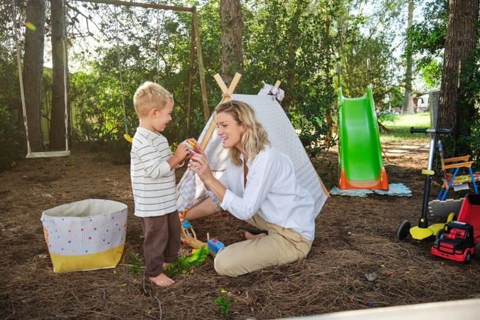 Mother and son playing with toy in park