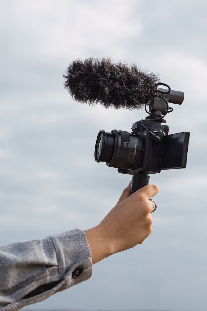 Anonymous female blogger shooting video on camera