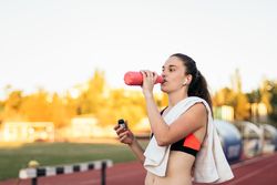 An athletic woman resting after running.
