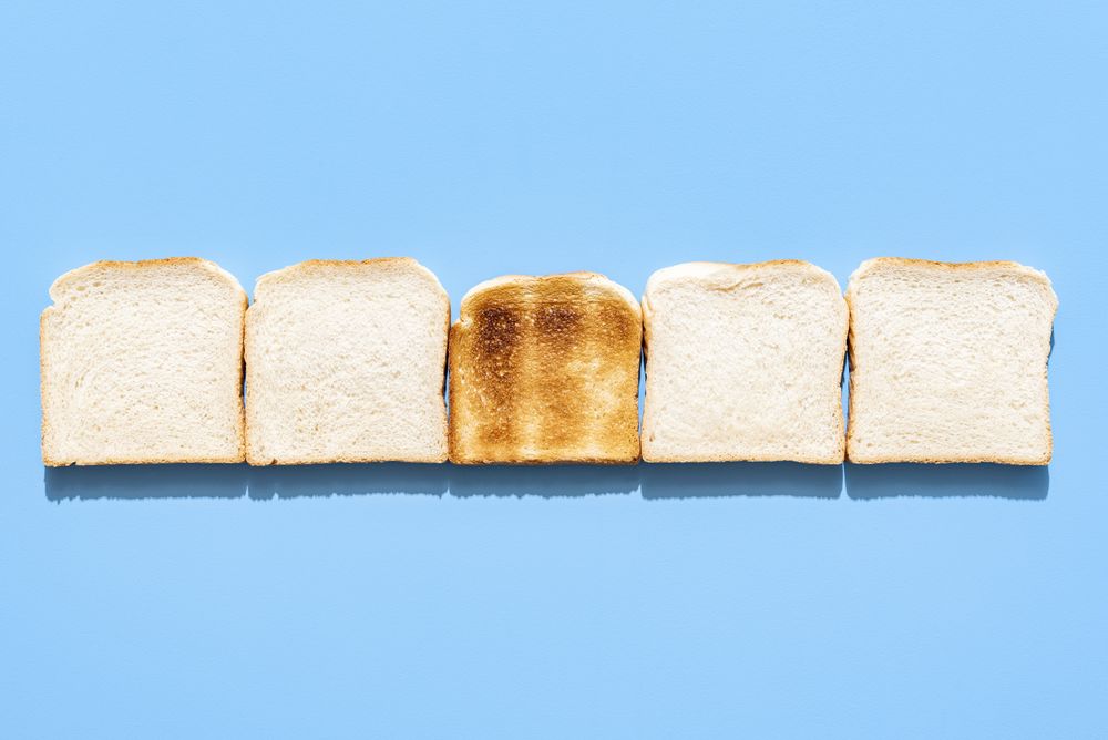 Slices of toast bread alligned in a row on a blue background