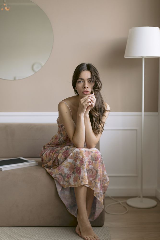 Pretty woman sitting at the end of a sofa