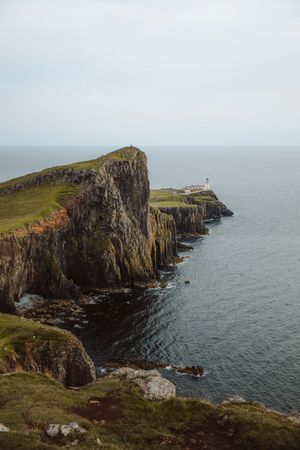 Picturesque view of lighthouse on cliff by sea