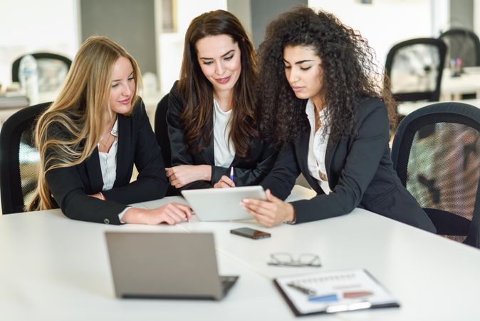 Team of women business leaders working in office on project