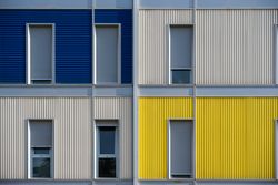 Facade of modern multicolored building with narrow windows