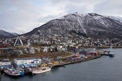 Wonderful cityscape against snowy highland in cold overcast weather