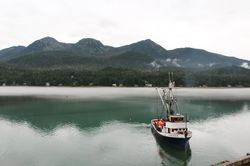 Lake with boat surrounded by hills