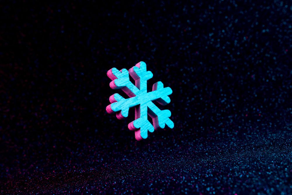 Snowflake in vivid neon colors on dark  background