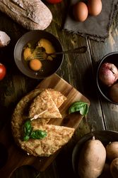Cooking ingredients around pie on table