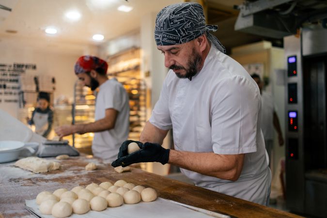 Baker making balls with the dough