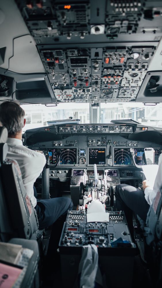 Back view of two pilots on duty