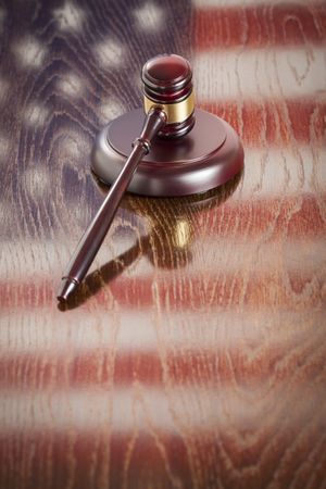 Wooden Gavel Resting on Flag Reflecting Table