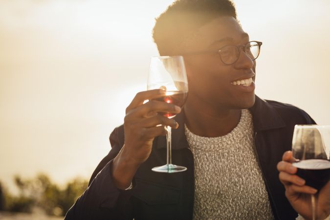 Young man enjoying a glass of wine with girlfriend