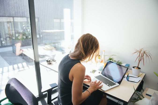 woman working in sunny modern office