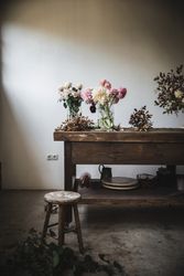 Bunches of flowers in vases on table
